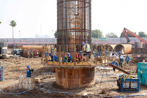 Workers install reinforcement cages for bored pile.