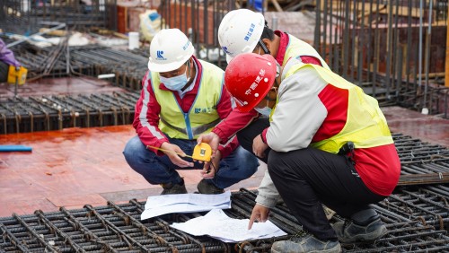 A site supervision team inspects and a the tying of rebars.